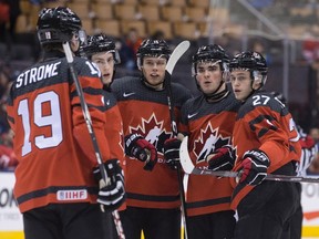 Canada's players celebrate a goal by Dante Fabbro (centre right) against Switzerland during first period exhibition action ahead of the world junior hockey championship in Toronto on Friday, Dec. 23, 2016. (Chris Young/The Canadian Press)