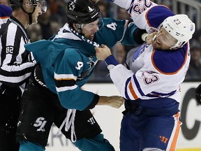 Brenden Dillon, left, of the San Jose Sharks and Matt Hendricks of the Edmonton Oilers fight during the first period at SAP Center on December 23, 2016 in San Jose, California.