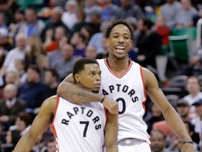 Raptors' Kyle Lowry (7) celebrates with teammate DeMar DeRozan (10) after scoring a bucket against the Jazz during second half NBA action in Salt Lake City, Utah, on Friday, Dec. 23, 2016. (Rick Bowmer/AP Photo)