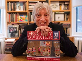 Roch Carrier poses for a portrait with his iconic book, "The Hockey Sweater," in Montreal in a file photo. THE CANADIAN PRESS/Ryan Remiorz