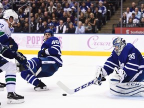 Maple Leafs goalie Jhonas Enroth makes a save on Canucks left wing Daniel Sedin (22) as Leafs defenceman Roman Polak (46) falls to the ice during third period NHL action in Toronto on Nov. 5, 2016. (Frank Gunn/The Canadian Press)