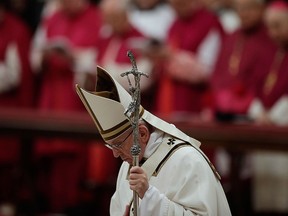 Pope Francis bows in front of the altar as he celebrates the Christmas Eve Mass in St. Peter's Basilica at the Vatican, Saturday, Dec. 24, 2016. (AP Photo/Alessandra Tarantino)