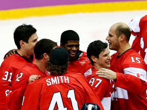 Team Canada captain Sidney Crosby (87), Ryan Getzlaf (15) along with other teammates celebrate winning gold after beating Team Sweden 3-0 in the men's hockey final at the Bolshoy Ice Dome during the Winter Olympics in Sochi, Russia, on Feb. 23, 2014. One gift for hockey fans this year is the NHL saying yes to participating at the 2018 Winter Olympics in South Korea. (Al Charest/Postmedia Network/Files)