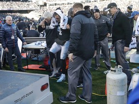 Raiders quarterback Derek Carr (4) is helped to a cart during the second half of a game against the Colts in Oakland, Calif., Saturday, Dec. 24, 2016. Carr broke a bone in his right leg and will have surgery. (Marcio Jose Sanchez/AP Photo)