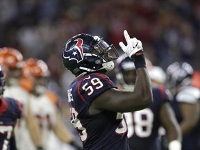 Texans' Whitney Mercilus celebrates after sacking Bengals quarterback Andy Dalton during second half NFL action in Houston on Saturday, Dec. 24, 2016. (Sam Craft/AP Photo)