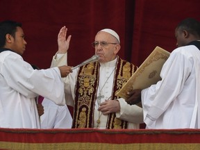 Pope Francis delivers the Urbi et Orbi (Latin for ' to the city and to the world' ) Christmas' day blessing from the main balcony of St. Peter's Basilica at the Vatican, Sunday, Dec. 25, 2016. (AP Photo/Alessandra Tarantino)