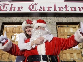 Santa and Mrs. Claus greet people during the 16th annual Christmas dinner at the Carleton Pub in Ottawa Sunday, December 25, 2016.