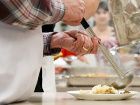 Volunteers work feverishly in the kitchen of The Salvation Army Community Church, filling up plates for more than 100 people at the annual Community Christmas Dinner on Sunday December 25, 2016 in Belleville, Ont. Tim Miller/Belleville Intelligencer/Postmedia Network