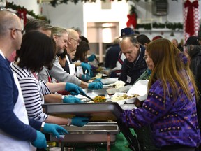 An army of volunteers serving up dinner at the 45th annual Christmas Dinner where they're planning to serve more than 2000 vulnerable people at the Sacred Heart Church in Edmonton, Sunday, December 25, 2016. Ed Kaiser/Postmedia