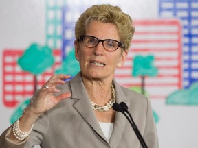 Ontario Premier Kathleen Wynne addresses the media during an announcement which outlined a cap and trade deal with Quebec aimed at curbing green house emissions, in Toronto on Monday, April 13 2015. (THE CANADIAN PRESS/Chris Young)