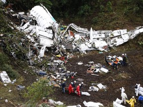 In this Nov. 29, 2016 file photo, rescue workers recover a body from the wreckage site of the LaMia chartered airplane crash, in La Union, a mountainous area near Medellin, Colombia. In a Monday, Dec. 26, 2016 statement, Colombian aviation authorities say a preliminary investigation has found that the plane that crashed just outside of Medellin with a Brazilian soccer team aboard had run out of fuel. Civil Aeronautics agency says the conclusion is based on the plane's black boxes and other evidence. (AP Photo/Fernando Vergara, File)