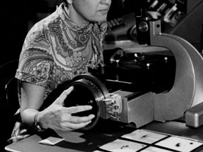 In this image taken in the 1970s and provided by the Carnegie Institution of Washington, Vera Rubin uses a measuring engine. Rubin, a pioneering astronomer who helped find powerful evidence of dark matter died Sunday, Dec. 25, 2016. She was 88. (Carnegie Institution of Washington via AP)