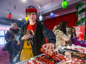 Charlie Fulton, 13, lays his stuff on the counter to score at the Skittles Holiday Pawn Shop on Queen St. W. (ERNEST DOROSZUK, Toronto Sun)