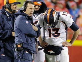 Denver Broncos head coach Gary Kubiak talks to quarterback Trevor Siemian during an NFL game against the Kansas City Chiefs on Dec. 25, 2016. (AP Photo/Charlie Riedel)