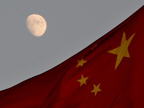 The Chinese flag is seen in front of a view of the moon at Tiananmen Square in Beijing on December 13, 2013.(MARK RALSTON/AFP/Getty Images)