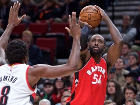 Toronto Raptors forward Patrick Patterson shoots over Portland Trail Blazers forward Al-Farouq Aminu during NBA action on Dec. 26, 2016. (AP Photo/Craig Mitchelldyer)