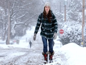 With sidewalks still piled with snow Fiona McNeill walks on the roads en route to school at the University of Ottawa in the Sandy Hill area.