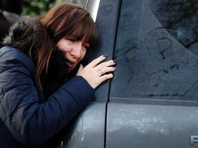 A woman cries outside the home of musician George Michael in London, Tuesday, Dec. 27, 2016. (AP Photo/Frank Augstein)