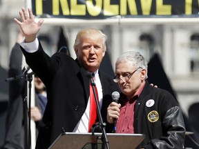 In this April 1, 2014, file photo, Donald Trump, left, is joined by Carl Paladino during a gun rights rally at the Empire State Plaza in Albany, N.Y. (AP Photo/Mike Groll, File)