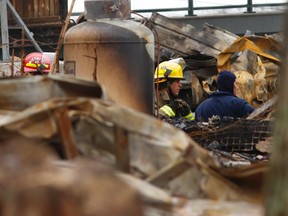 The Office of the Fire Marshal is battling icy conditions with assistance from Douro-Dummer Township firefighters as investigators probe the cause of a fire that claimed four lives on Christmas Eve on Tuesday December 27, 2016 in Peterborough, Ont. Toronto lawyers Geoff Taber and  Jackie Gardner and their sons, 15-year-old Scott and 13-year-old Andrew, died in the fire early on the morning of Christmas Eve. The blaze broke out in their cottage near McCracken's Landing on Stoney Lake. Clifford Skarstedt/Peterborough Examiner/Postmedia Network