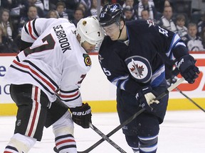 Winnipeg Jets centre Mark Scheifele (right) and Chicago Blackhawks defenceman Brent Seabrook butt heads. The Jets play the Hawks Tuesday night in Chicago. (Kevin King/Winnipeg Sun file photo)