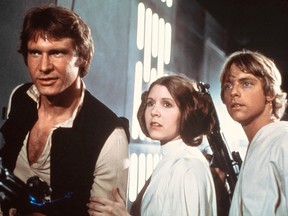 In this 1977 image provided by 20th Century-Fox Film Corporation, from left, Harrison Ford, Carrie Fisher, and Mark Hamill are shown in a scene from "Star Wars" movie released by 20th Century-Fox. (AP Photo/20th Century-Fox Film Corporation)