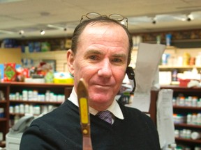 Jeff Robb, the owner of Turner Drugs at the corner of Carfrae Cresent and Grand Avenue in south London, Ont. shows the druggist's spatula, a narrow metal blade that he threw at would be drug thieves at his store Tuesday. (MIKE HENSEN, The London Free Press)