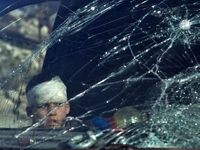 A wounded boy sits inside an ambulance as Syrian rebels and their families gather at the rebel-held al-Amiriyah neighbourhood as they wait to be evacuated to the government-controlled area of Ramoussa on the southern outskirts of the city on December 15, 2016. Russia, Syrian military sources and rebel officials confirmed that a new agreement had been reached after a first evacuation plan collapsed the day before amid fresh fighting. Syrian state television reported that some 4,000 rebels and their families were to be evacuated. (KARAM AL-MASRI/AFP/Getty Images)