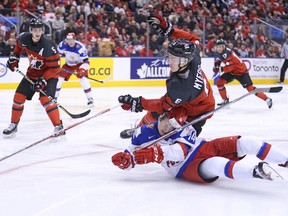 Kirill Belyayev of Team Russia gets run over by Philippe Myers of Team Canada during a world juniors game at the Air Canada Centre on Dec. 26, 2016. (Claus Andersen/Getty Images)