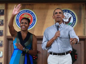 President Barack Obama and first lady Michelle Obama, arrive for an event to thank service members and their families at Marine Corps Base Hawaii, in Kaneohe Bay, Hawaii, Sunday, Dec. 25, 2016. (AP Photo/Carolyn Kaster)