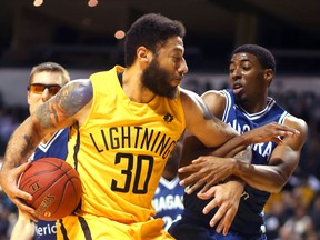 Royce White of the London Lightning gets fouled by Marcus Lewis of the Niagara River Lions at Budweiser Gardens on Monday night. (MIKE HENSEN, The London Free Press)