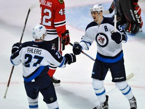 Winnipeg Jets' Mark Scheifele (55) celebrates with teammate Nikolaj Ehlers (27) after scoring a goal during the first period of an NHL hockey game against the Chicago Blackhawks Tuesday, Dec. 27, 2016, in Chicago. (AP Photo/Paul Beaty)