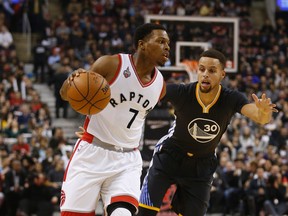 Stephen Curry of the Golden State Warriors defends Kyle Lowry of the Toronto Raptors on Dec. 5, 2015. (JACK BOLAND/Toronto Sun files)