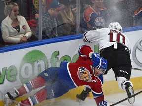 Oil Kings forward Aaron Irving is knocked down by Rebels' Evan Polei in this shot from a September game. The Oil Kings lost 3-0 to the Rebels Tuesday, and will look for revenge in a rematch at Rogers Place on Wednesday. (Ed Kaiser)