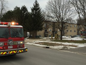 Firefighters remain at the scene Wednesday morning at 374 Simcoe Street in London after a fire in an apartment unit sent one resident to hospital. John Miner/The London Free Press/Postmedia Network