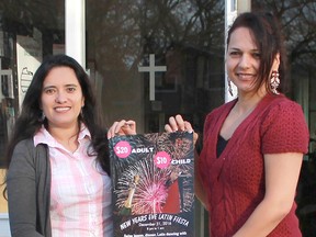 Organizers Nayi Rincon and Claudia Martinez hold up a poster for the Catholic Hispanic Community of Sarnia-Lambton's first-ever New Year's Eve Latin Fiesta. It takes place at St. Thomas Aquinas Parish Hall on Dec. 31. Carl Hnatyshyn/Postmedia Network