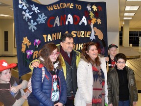 Suzi Daghlian, Tanil Kahiaian and their kids, Rozemerry 16, and Dikran, 12, Kahiaian arrive at the London Airport last February. The refugee family from Syria has been sponsored by the Sarnia-Lambton Peoples Church. Also pictured are sponsor group members Joseph Klassen, left, and LeRoy Campbell. (Handout)