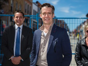 Nick Tardif/The Whig-Standard
James Ward of Rogers Trainor, Brett Christopher of Kingston Theatre Alliance, and Michele Langlois, marketing manager at Downtown Kingston, stand together at Bagot and Princess streets in front of the Big Dig in April to promote the annual Kick & Push festival.