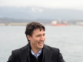 Prime Minister Justin Trudeau has a laugh as he tours a tugboat in Vancouver Harbour, Tuesday, Dec. 20, 2016. (THE CANADIAN PRESS/Jonathan Hayward)