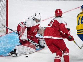 Sweden's Carl Grundstrom moves in on Denmark goaltender Lasse Petersen during IIHF World Junior Championship action in Montreal on Dec. 26, 2016. (THE CANADIAN PRESS/Graham Hughes)