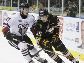 From left, Guelph Storm centre James McEwan and Sarnia Sting forward Nikita Korostelev battle for body position in this Postmedia file photo. The Storm defeated the Sting 4-3 in overtime Wednesday night in Guelph. Terry Bridge/Sarnia Observer/Postmedia Network