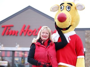 Lesli Green, president of Operation Red Nose, and Rudy the mascot pose in front of the Tim Hortons on Lasalle Boulevard in this file photo.  (Gino Donato/Sudbury Star)