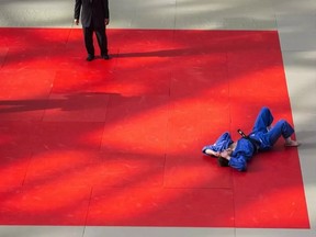 Jasmin Boisvert lies on the floor after being defeated in the Mens Black Belt 66Kg final by Matt Roots, (not seen). The Edmonton International Judo Championships hosted about 700 athletes from all over Canada at the Mayfield Toyota Ice Palace in West Edmonton Mall. Shaughn Butts / POSTMEDIA