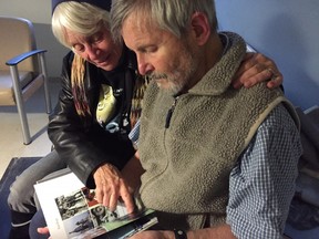 Ed and Mary Farrar look over an album of family photos in Kingston, Ont. Paul Schliesmann Kingston Whig-Standard