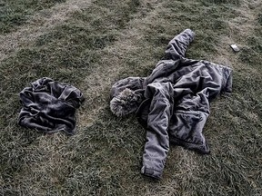 The frost-covered clothing of Edmonton's 36th homicide victim lays in a field on Sunday October 23, 2016.