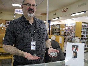 Reference librarian Jeff Beeler shows off some of his Star Wars ships and a sign in honour of the late actress Carrie Fisher at the downtown Sarnia library branch Thursday. More than 20 people gathered for an afternoon screening of Star Wars: The Force Awakens as part of the library's annual Star Wars Day. (Barbara Simpson/Sarnia Observer/Postmedia Network)