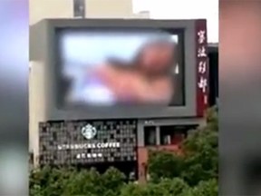 A screen grab shows porn being played outside a mall in China.