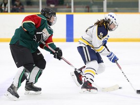 Emilie Byers of Ecole Secondaire Catholique L'Horizon and Vanessa McKinnon of the the College Notre Dame Alouettes battle for the puck during girls high school hockey action in Sudbury, Ont. on Tuesday November 15, 2016. The Als are the only team with a perfect record at the holiday break at 6-0. Gino Donato/Sudbury Star/Postmedia Network