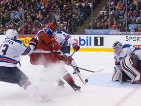 Team Russia's Yakov Trenin (centre) shoots on Team USA goaltender Tyler Parsons during second period IIHF World Junior Championship action in Toronto, on Thursday, December 29, 2016.THE CANADIAN PRESS