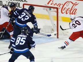 Columbus Blue Jackets' Brandon Saad scores on Michael Hutchinson on Thursday night. (JOHN WOODS/Canadian Press)